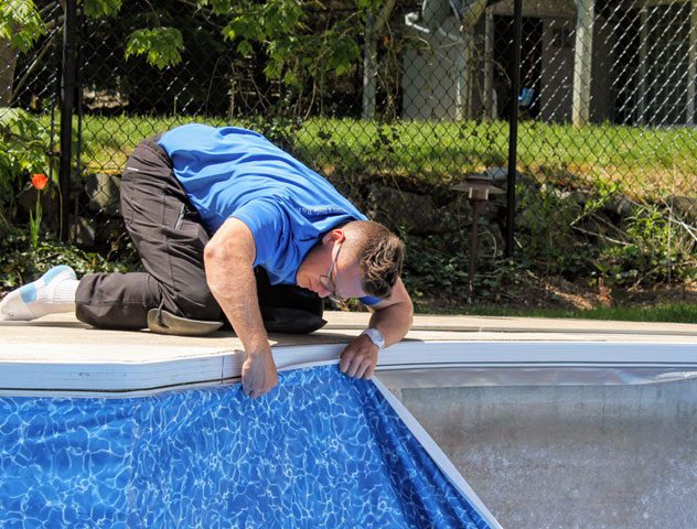 Pool technician installing a vinyl pool liner